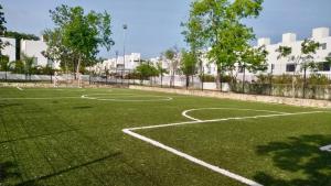 an empty soccer field with a soccer ball at Victoria Comfort Condo in Playa del Carmen