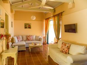 a living room with a couch and a table at Manto On The Beach Apartments in Barbati