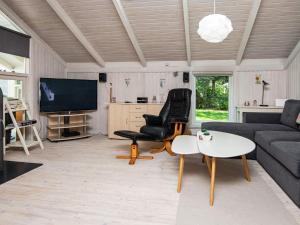 a living room with a couch and chairs and a tv at 6 person holiday home in Ulfborg-By Traum in Ulfborg +32 photos