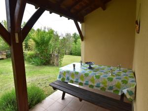 a table with a table cloth on top of a patio at Holiday home with private garden in Cazals