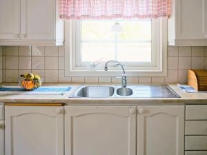 a kitchen counter with a sink and a window at 6 person holiday home in Trollhättan in Trollhättan