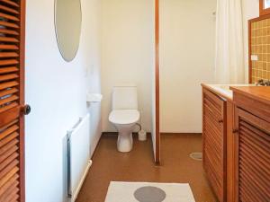 a bathroom with a toilet and a sink and a mirror at 6 person holiday home in Trollhättan in Trollhättan