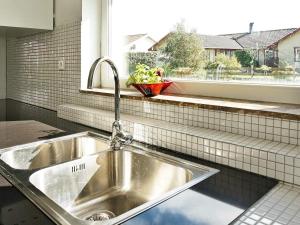 a stainless steel sink in a kitchen with a window at 5 star holiday home in Glommen in Falkenberg