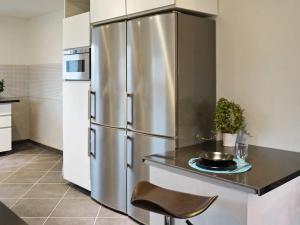 a kitchen with a stainless steel refrigerator at 5 star holiday home in Glommen in Falkenberg
