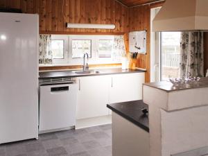 a kitchen with a white refrigerator and a sink at 10 person holiday home in Thisted-By Traum in Klitmøller +50 photos