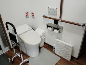 a bathroom with a white toilet and a radiator at Barrier Free Guesthouse Support Included in Osaka +68 photos