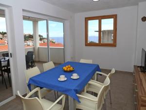 a dining room with a blue table and chairs at Holiday Home in Korcula with Sea View in Zavalatica