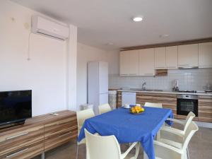 a kitchen with a table with a blue table cloth at Holiday Home in Korcula with Sea View in Zavalatica +17 photos