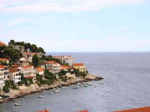 a group of boats in the water next to houses at Holiday Home in Korcula with Sea View in Zavalatica
