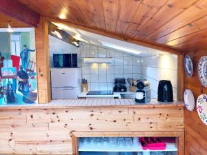 a kitchen with wooden walls and a counter in a room at Vintage chalet in a very beautiful landscape in Aywaille +26 photos