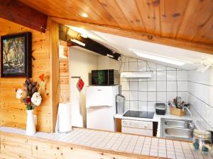 a kitchen with a refrigerator and a sink at Vintage chalet in a very beautiful landscape in Aywaille