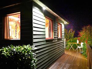 a house with a wooden deck with a table on it at Chalet in Sougnי-Remouchamps in Aywaille