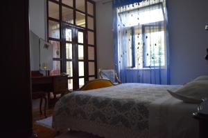 a bedroom with a bed and a window and a desk at Guesthouse Harašić in Split