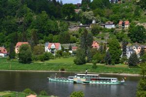 ein großes Boot auf einem Fluss in einem Dorf in der Unterkunft Haus Abendsonne in Stadt Wehlen