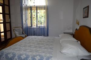 a bedroom with a bed and a window and a window at Guesthouse Harašić in Split