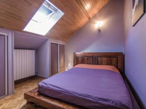 a bedroom with a large bed with a skylight at Villa with Pool & Views in Sérilhac in Beynat