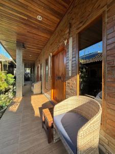 a porch of a house with a bed on a porch at Pondok Rangket Canggu in Canggu