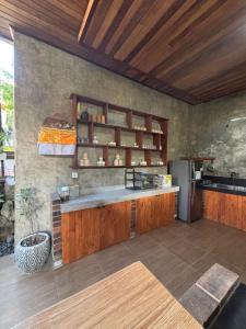 a kitchen with a counter and a refrigerator at Pondok Rangket Canggu in Canggu