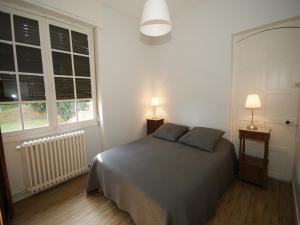 a bedroom with a bed with two pillows on it at Elegant Mansion Stay in Belvès in Belvès