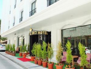 a store front of a hotel with potted plants on the sidewalk at Royal İnci Hotel in Istanbul