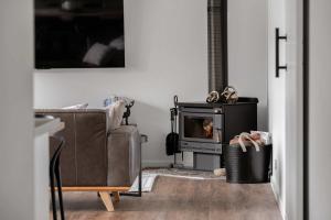 a living room with a couch and a fireplace at Luxury On Lakeside in Mount Beauty
