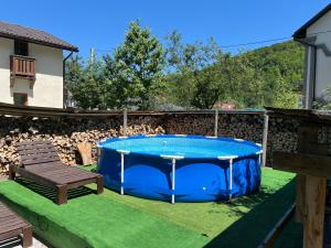 a pool in the middle of a yard with a bench at Guest House Plai in Yaremche