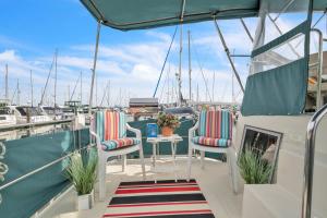 a deck with chairs and a table on a boat at Luxury 2BR Yacht • Marina Views • WiFi in Anacortes