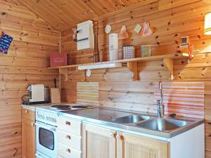 a kitchen with a sink and a stove at 4 person holiday home in Strömstad in Strömstad +28 photos