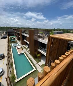 an external view of a building with a swimming pool at Beira mar porto de pedras essence C101 in Pôrto de Pedras