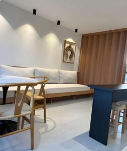 a living room with a couch and a table at Beira mar porto de pedras essence C101 in Pôrto de Pedras +30 photos