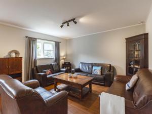 a living room with leather furniture and a table at Holiday Home in Meliskerke near Beaches in Meliskerke +27 photos