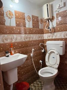 a bathroom with a toilet and a sink at Anna Miracle Homestay in Kāsarkod