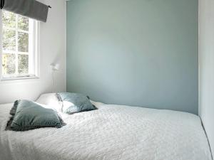 a bedroom with a bed with two pillows on it at Serene Seaside Retreat in Adelso-By Traum in Adelsö
