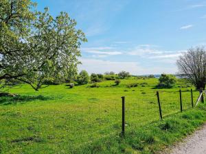 a fence in the middle of a field of grass at Serene Seaside Retreat in Adelso-By Traum in Adelsö