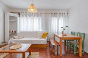 a living room with a bed and a table at Blue House Burgau in Burgau