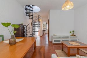 a living room with a table and a dining room at Blue House Burgau in Burgau