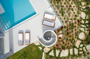 an overhead view of a swimming pool with a swimming pool at White Grace - A Seductive World of Luxury in Pigi