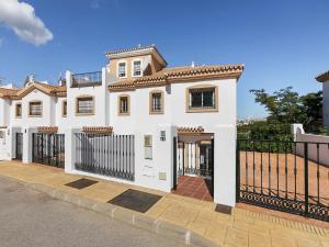 a white house with a black fence at Alhaurín Villa with Terrace in Alhaurín el Grande
