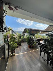 a patio with a table and potted plants on a balcony at Café The Wall in Pushkar +13 photos