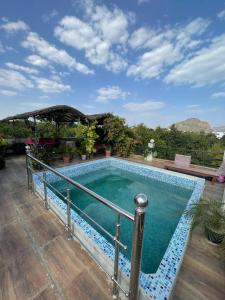 a swimming pool with a metal railing around it at Café The Wall in Pushkar
