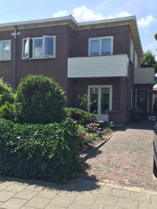 a brick house with a brick driveway at Studio De Laan in Zandvoort