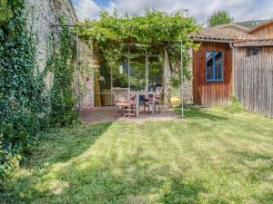 a patio with a table and chairs in a yard at Cozy Nature Stay in Diois in Ponet-et-Saint-Auban