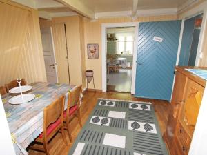 a dining room with a table and a blue door at 8 person holiday home in Kvås in Kvås +10 photos