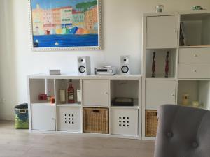 a living room with a white entertainment center with speakers at 2 Bedrooms Appartement In Central Location on the famous Place Massena Nice in Nice
