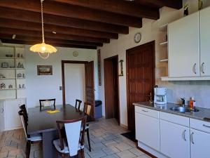 a kitchen with a table and a kitchen with white cabinets at Holiday Home in Vieure near Lake and Garden in Ygrande +32 photos