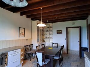 a kitchen and dining room with a table and chairs at Holiday Home in Vieure near Lake and Garden in Ygrande