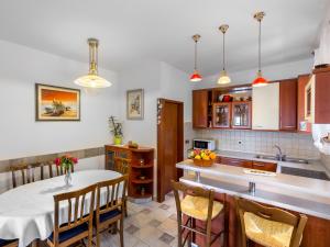 a kitchen with a table and a dining room at Apartment Nika in Opatija