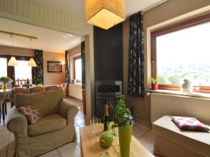 a living room with a couch and a table at Ondenval Stay with Sauna in Waimes +32 photos