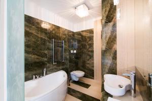 克盧奇堡的住宿－Restauracja Joanna，带浴缸、卫生间和盥洗盆的浴室