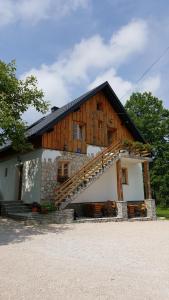 a house with a staircase in front of it at Guest House Plitvice Waterfall in Plitvička Jezera